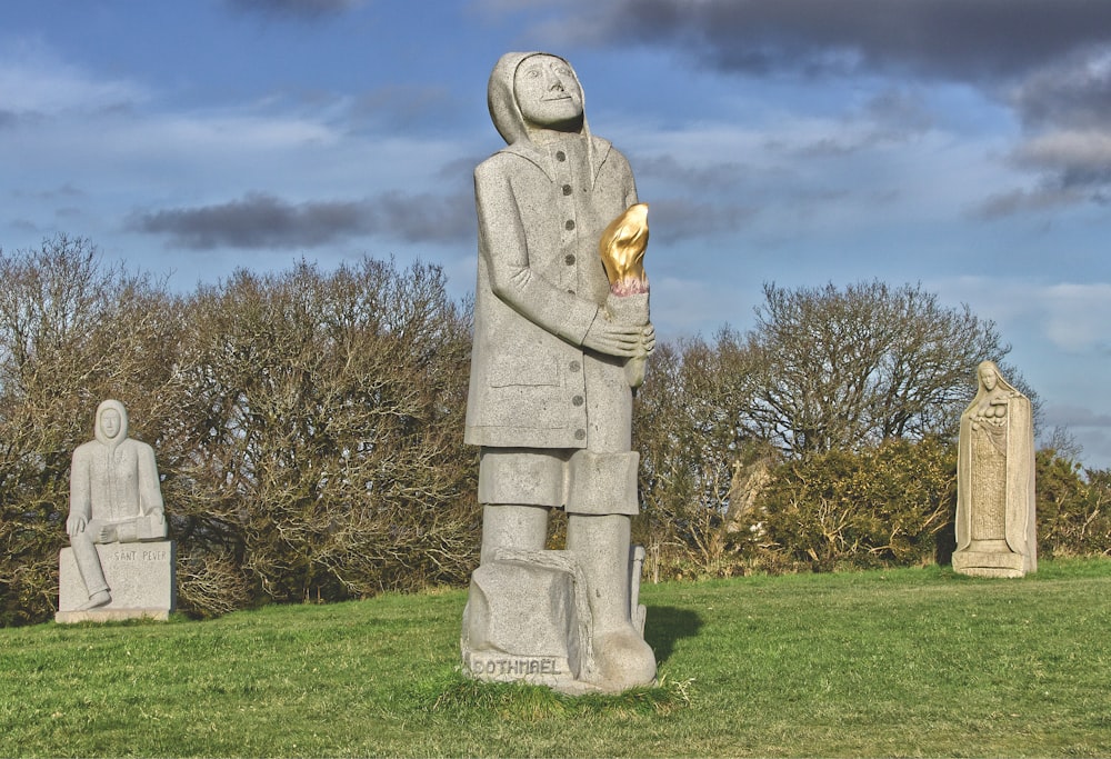 a statue of a man holding a gold piece