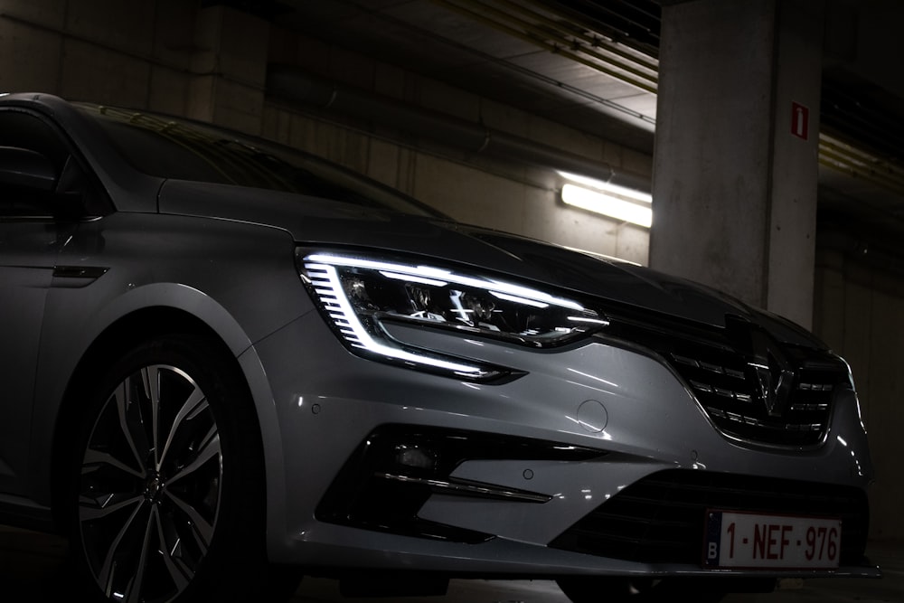 a car parked in a parking garage at night