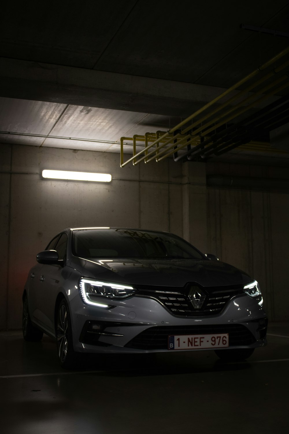 a car parked in a parking garage at night