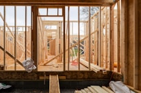 Wood framing structure rising on a sunny construction site, showcasing craftsmanship in progress.