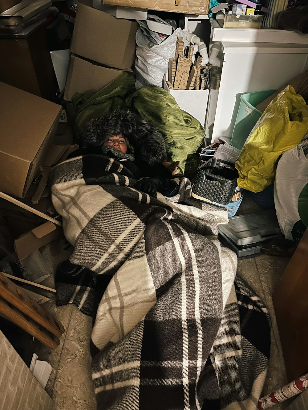 a pile of boxes and blankets in a room