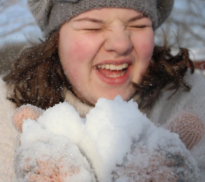 Laughter-filled moments from a winter camp with kids building a snowman.