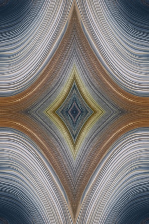 An abstract design featuring a symmetrical, kaleidoscopic pattern with curved lines converging towards a central diamond shape. The lines exhibit a variety of textures and gradients, creating an intricate visual effect reminiscent of layered fabric or natural formations.