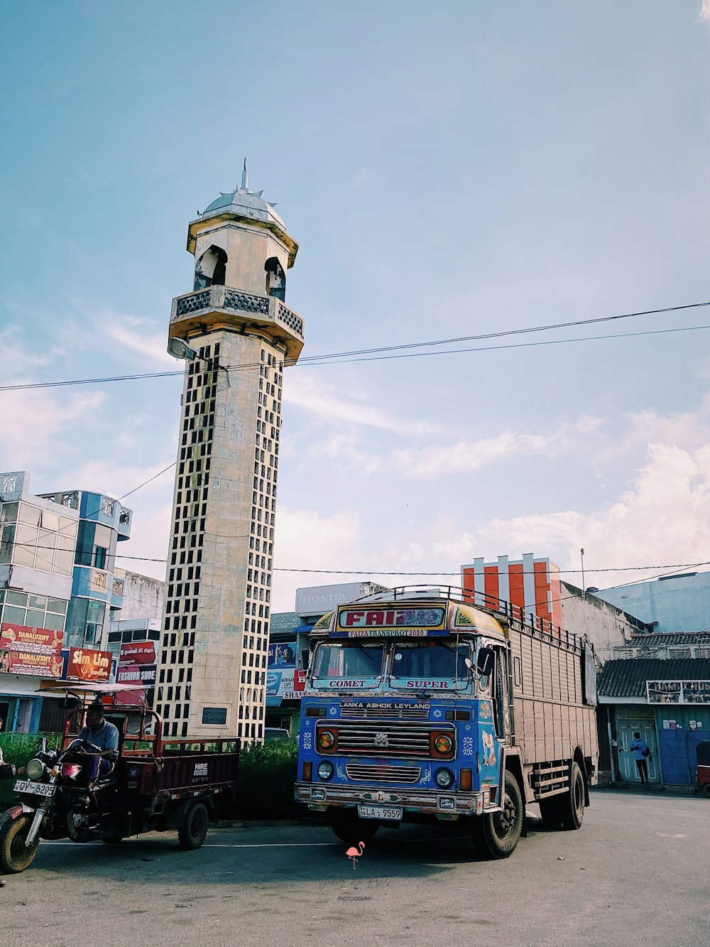 a truck parked in front of a tall tower