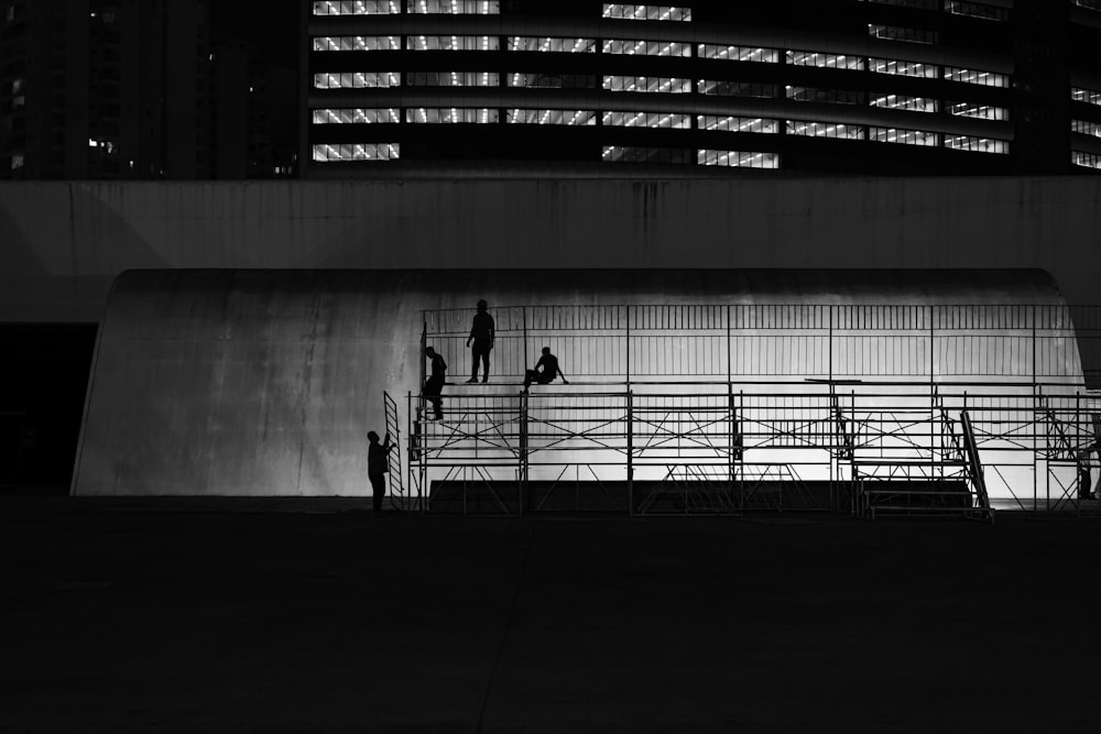 a black and white photo of people on scaffolding