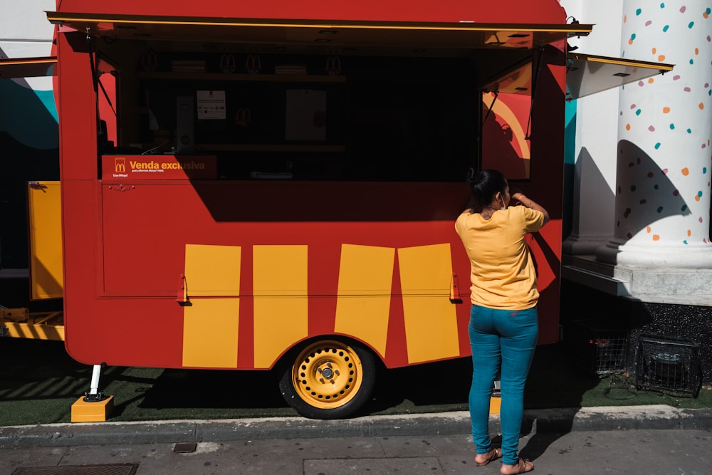 a woman standing in front of a food truck