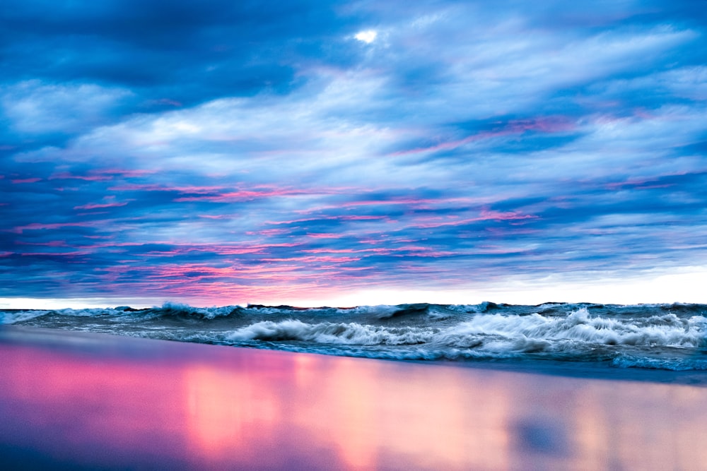a pink and blue sky over the ocean