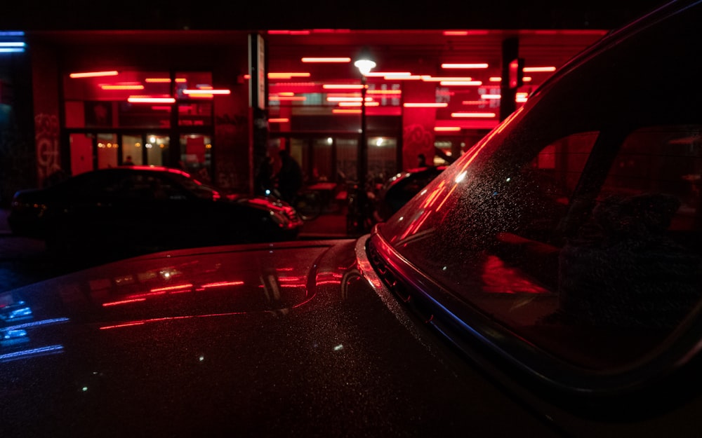 a car parked in front of a building at night