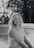 a woman in a dress is smiling for the camera
