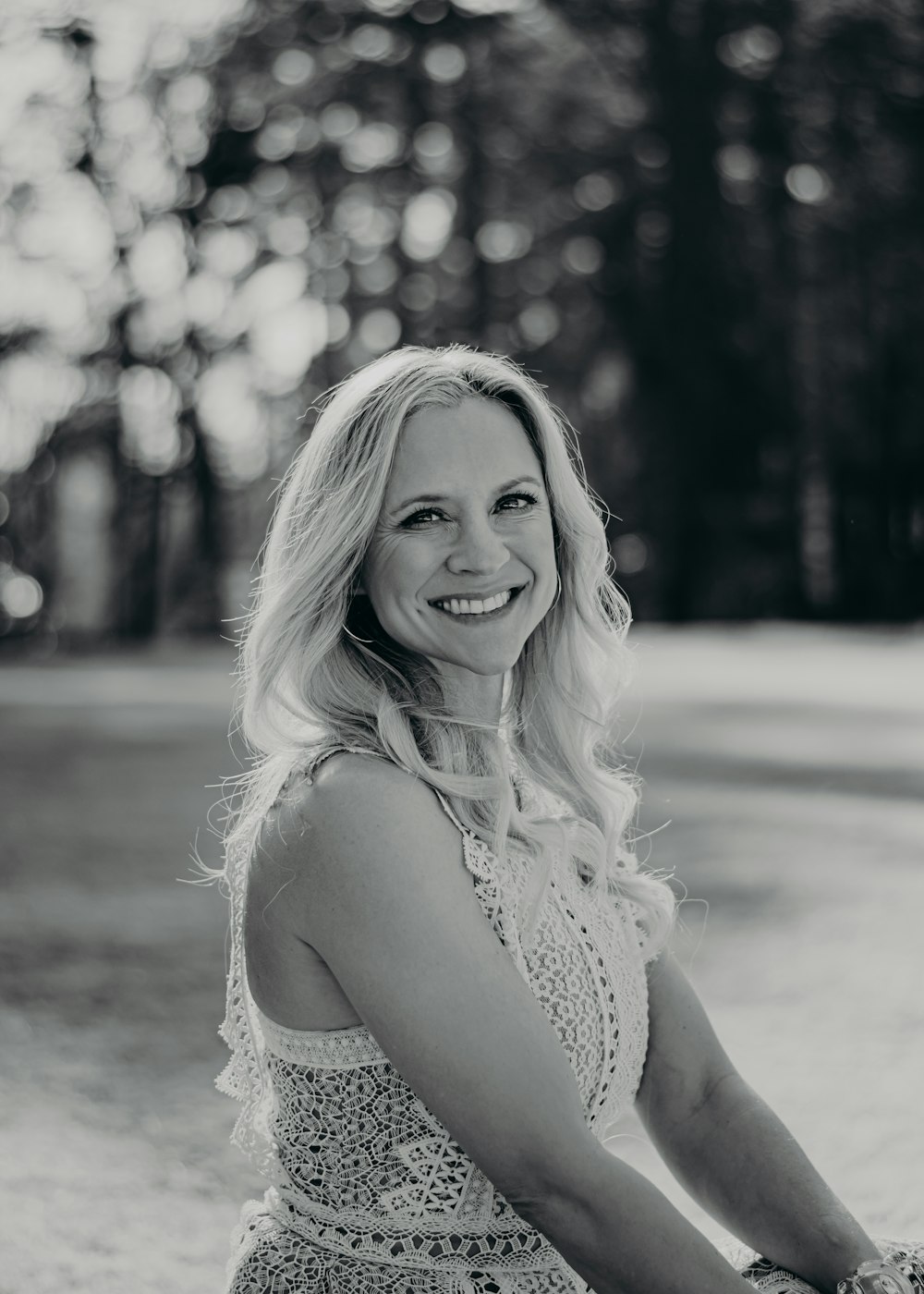 a woman in a dress is smiling for the camera