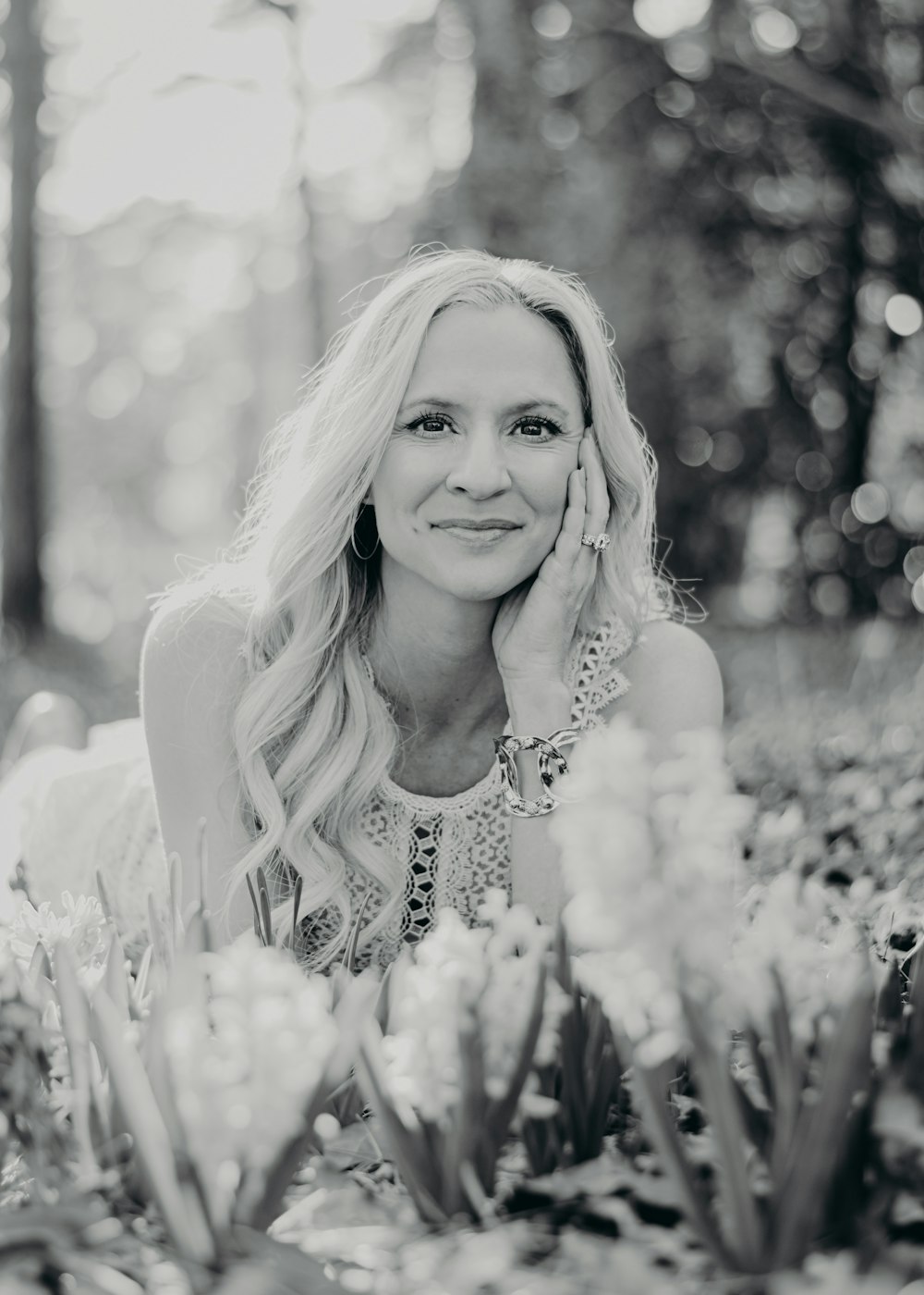 a black and white photo of a woman laying on the ground