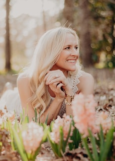 a woman laying on the ground in the woods