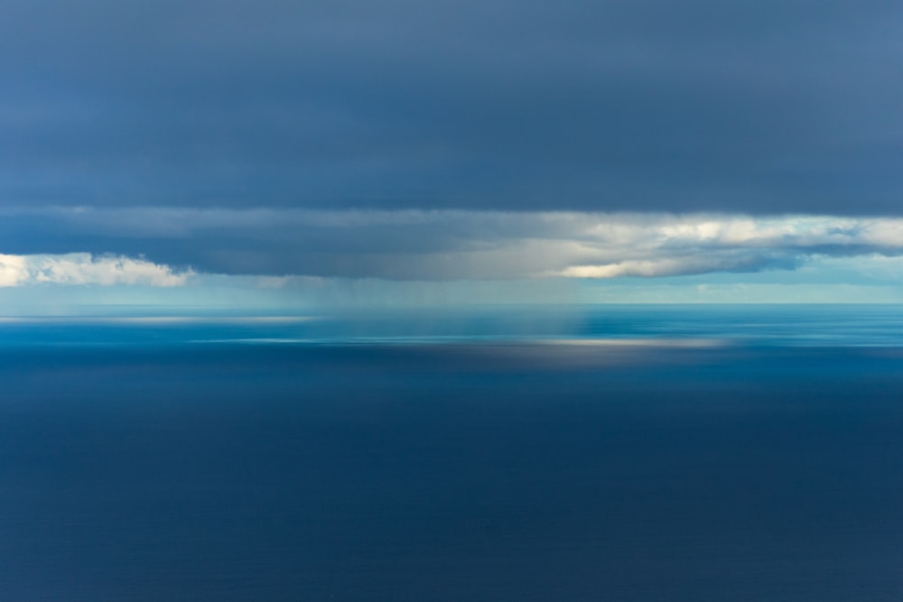 a large body of water under a cloudy sky