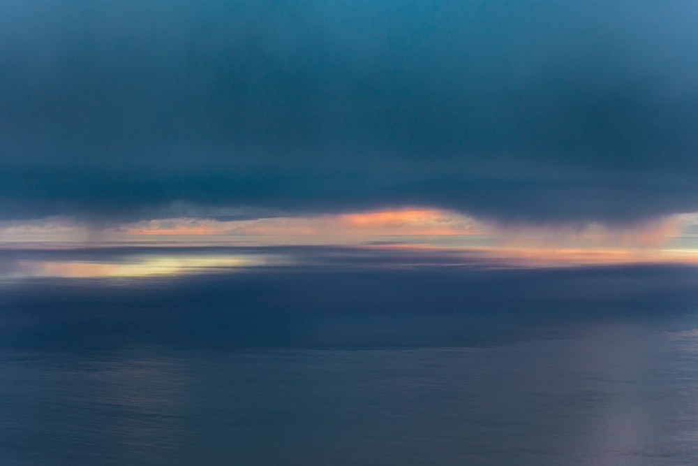 a large body of water under a cloudy sky