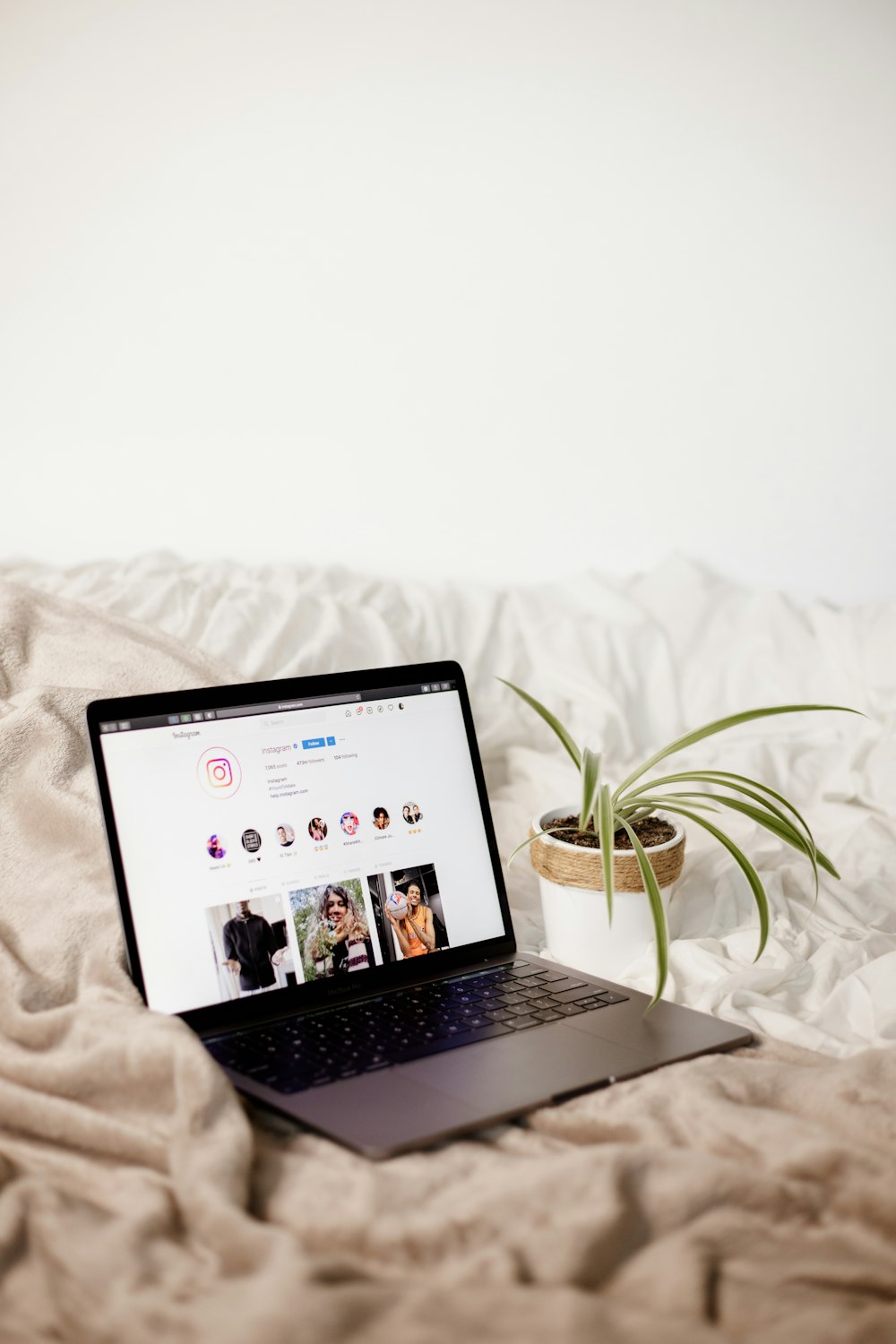 a laptop computer sitting on top of a bed