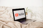 a laptop computer sitting on top of a bed
