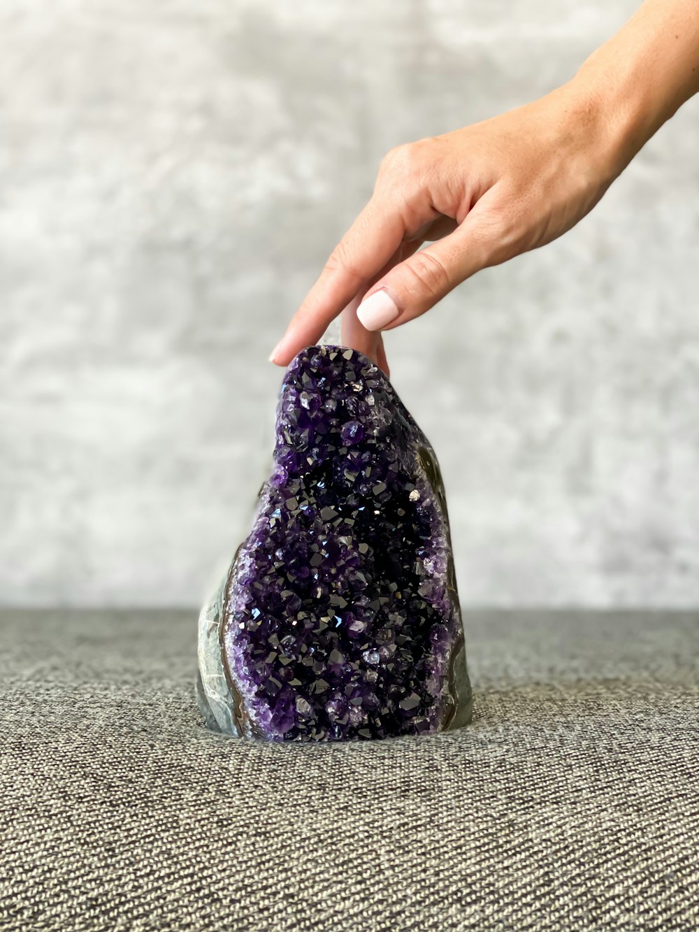 a person touching a rock with their hand