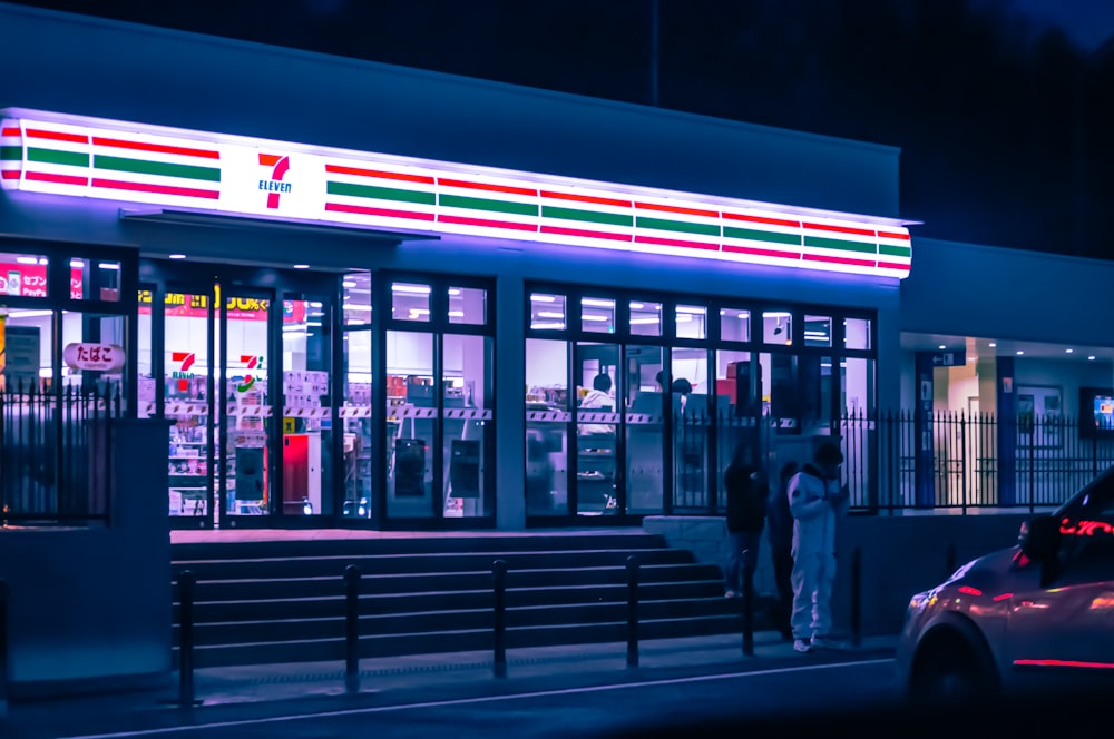 a car parked in front of a store at night