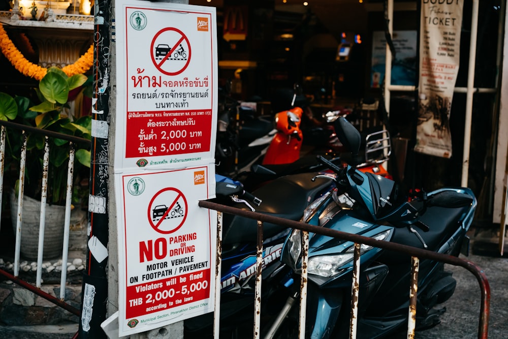 a motorcycle parked next to a no parking sign