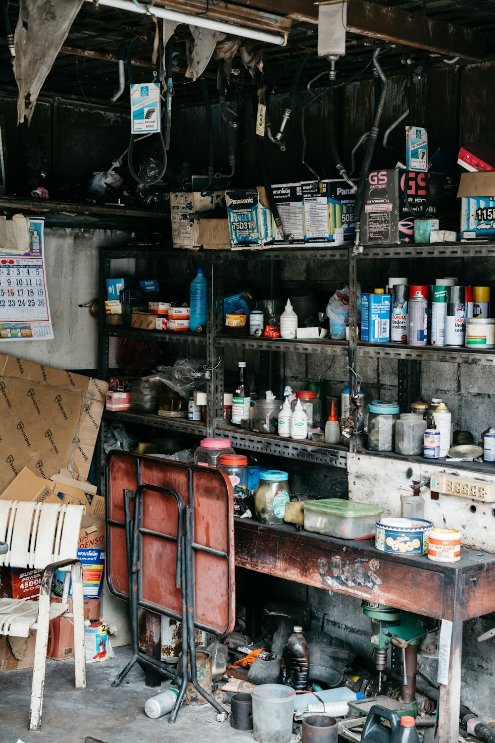 a room filled with lots of clutter next to a wooden table