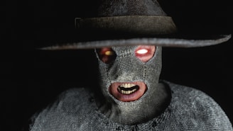 a man wearing a hat and a creepy mask