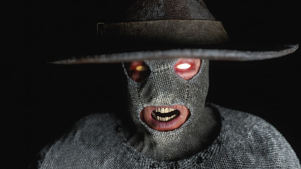 a man wearing a hat and a creepy mask