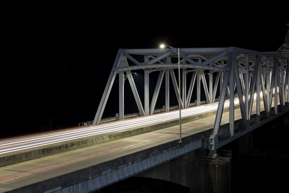 a long exposure photo of a bridge at night