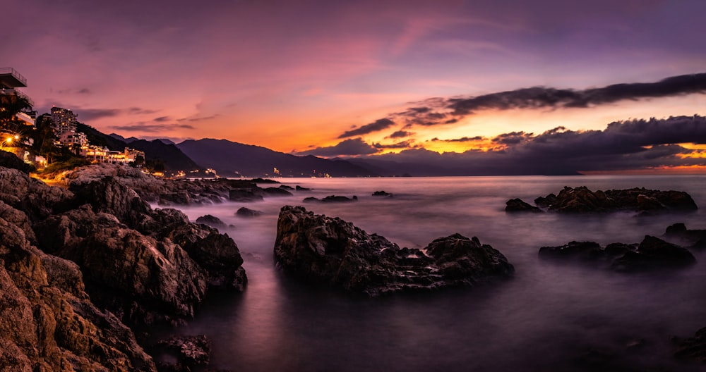 a long exposure photo of a sunset over the ocean