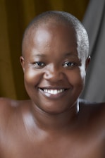 A hopeful survivor receiving community support with a bright smile.