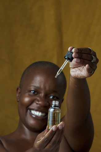 a woman holding a small bottle with a key in it