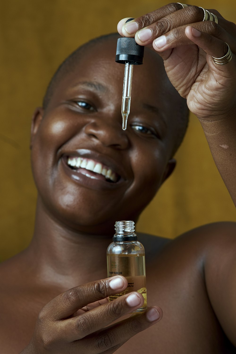 a smiling woman holding a bottle of medicine