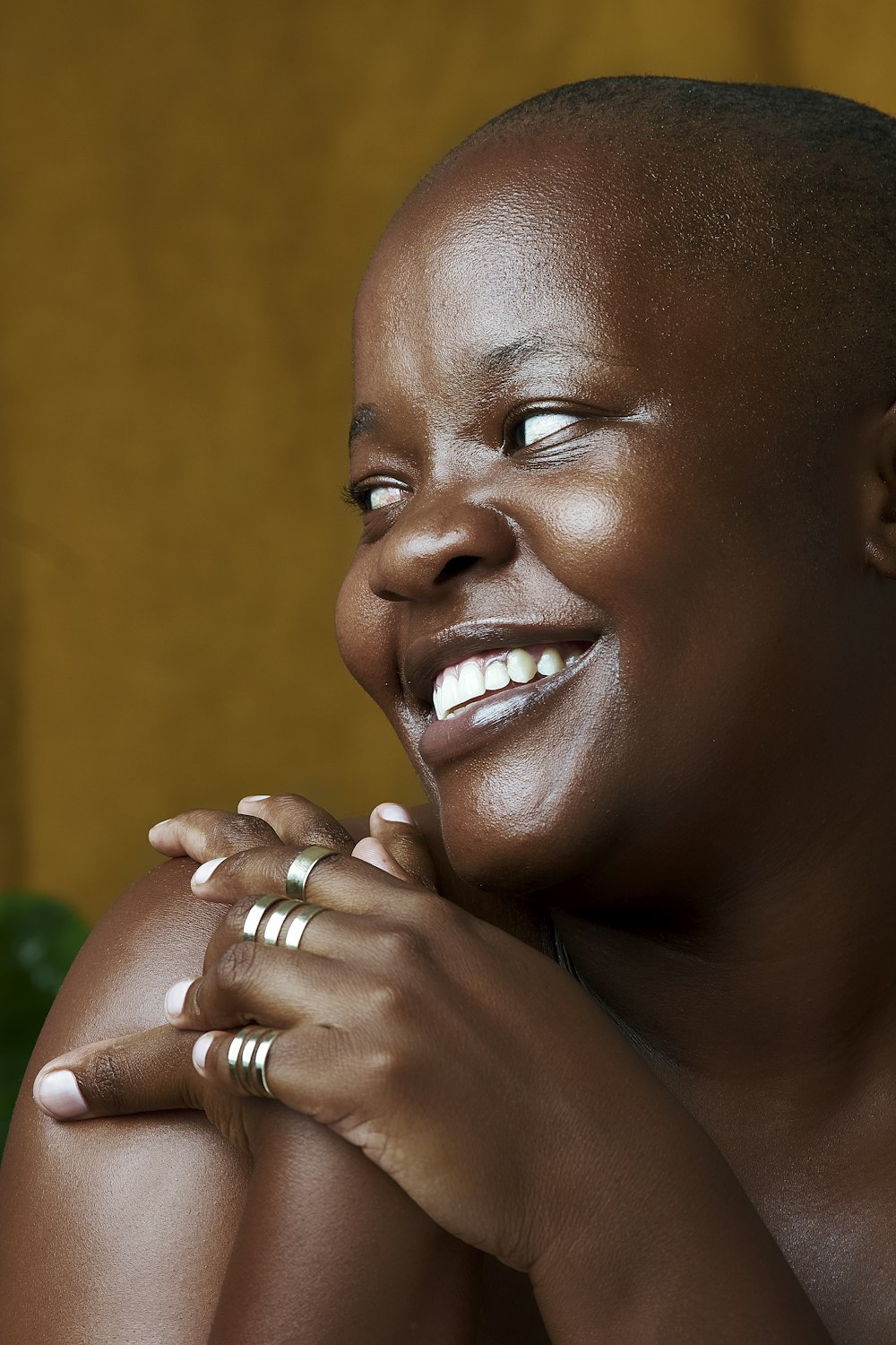 a smiling woman with her hands on her chest