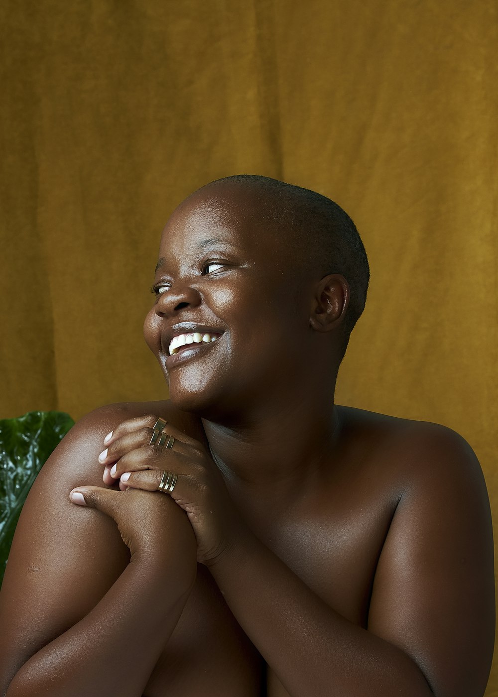 a naked black woman sitting on a green chair