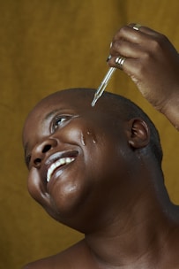 a man is getting his hair cut by a woman
