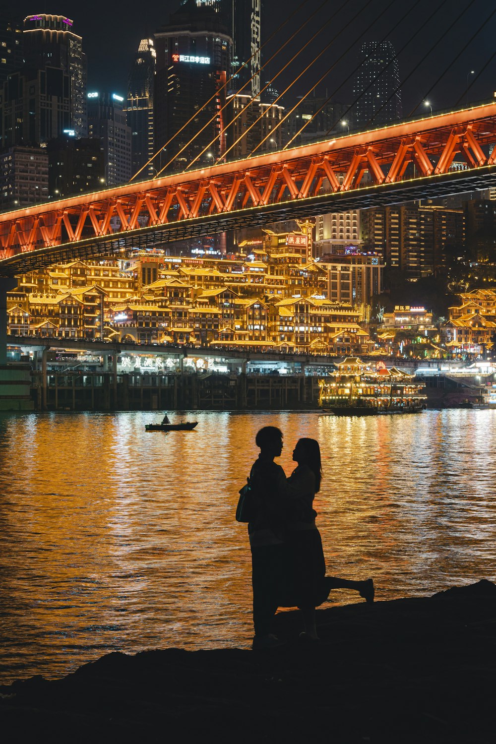 a man and a woman sitting next to each other near a body of water