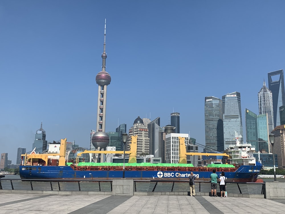 a large boat sitting in a harbor next to a city