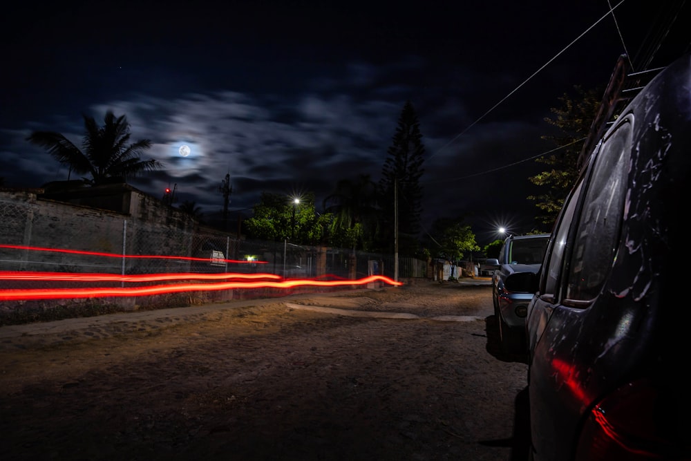 a car parked on the side of a road at night