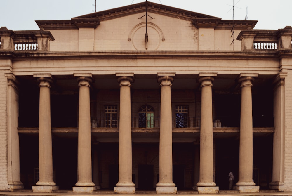 a large building with columns and a clock tower