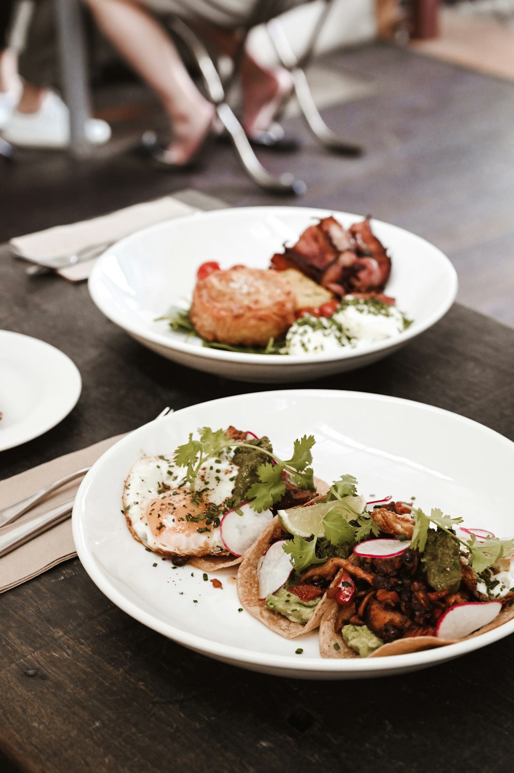 two plates of food are sitting on a table