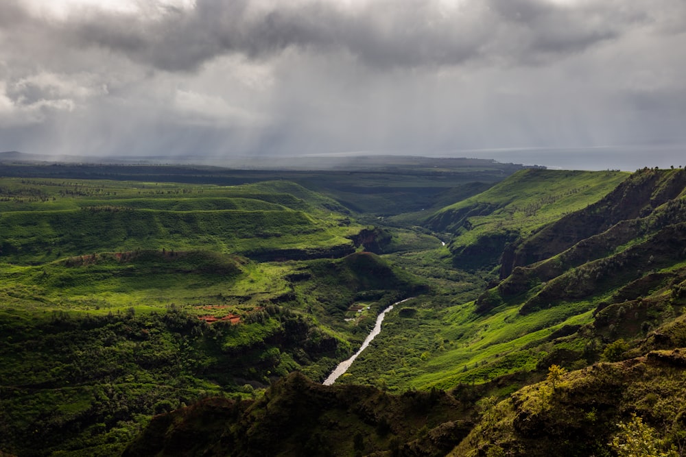 a river running through a lush green valley