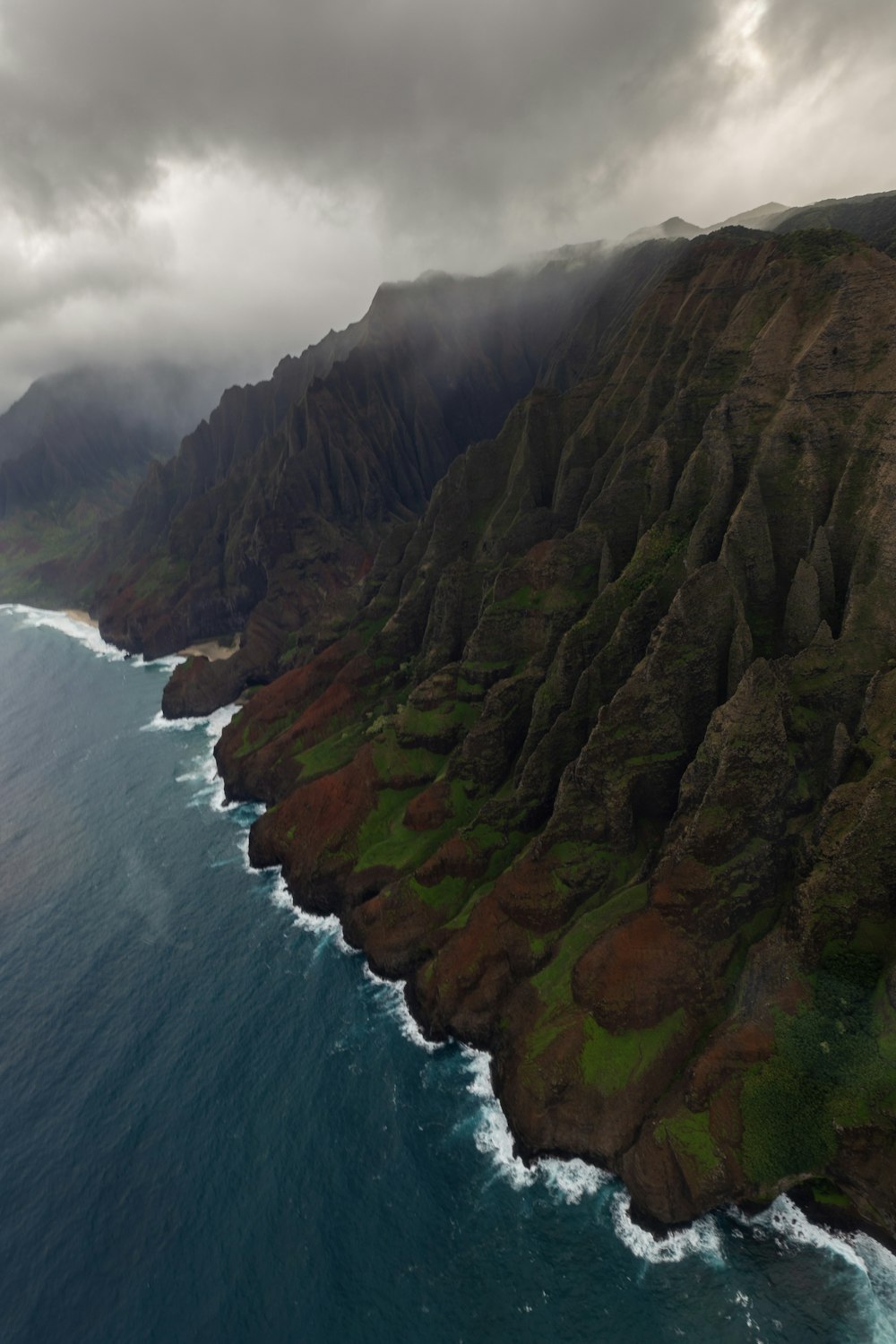 an aerial view of the ocean and mountains