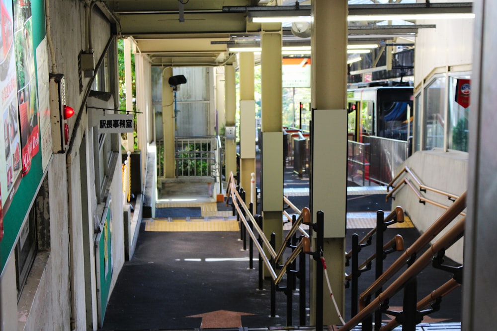 a long hallway with stairs leading up to a building