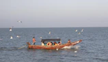 a group of people on a boat in the water