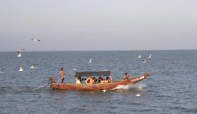 a group of people on a boat in the water