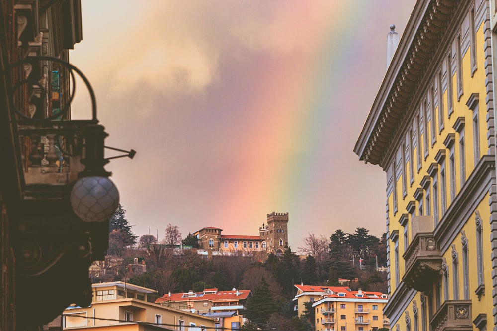 a rainbow in the sky over a city