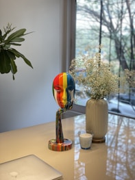 a table with a vase and a phone on it