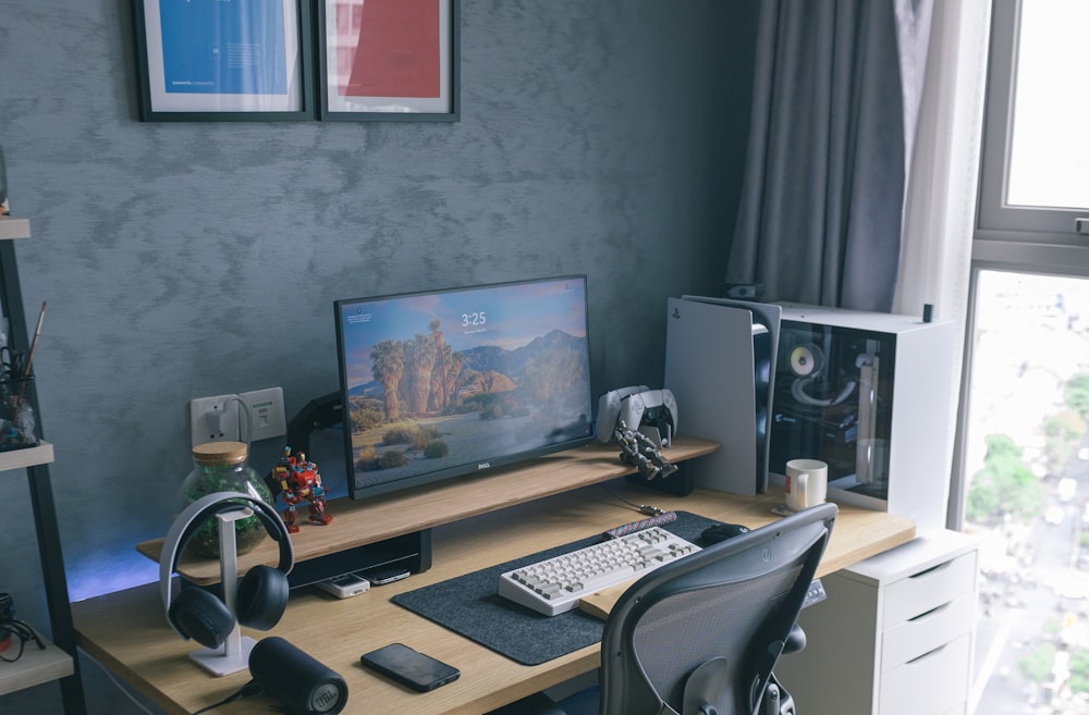 a computer desk with a monitor and keyboard