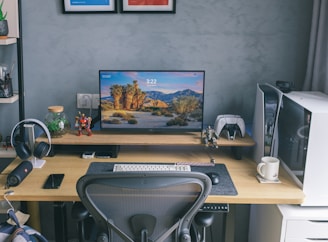 a desk with a computer and headphones on it