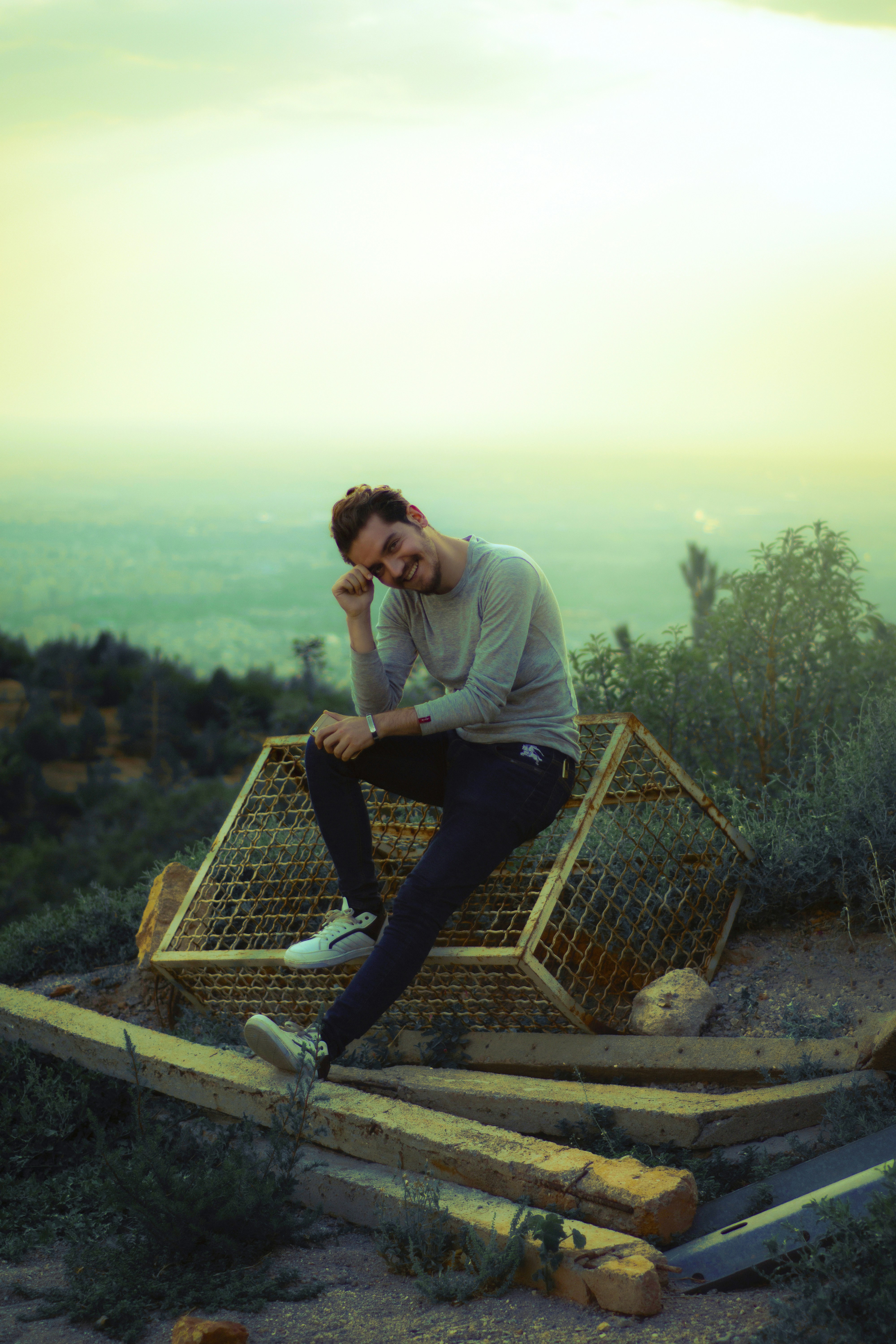 a man sitting on top of a wooden structure