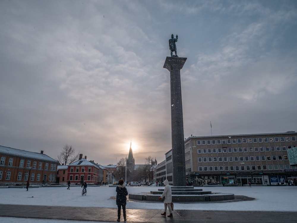 a couple of people that are standing in the snow